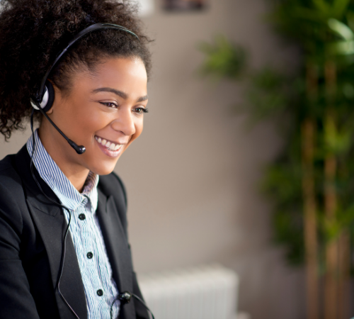 female customer service agent smiling with headset on