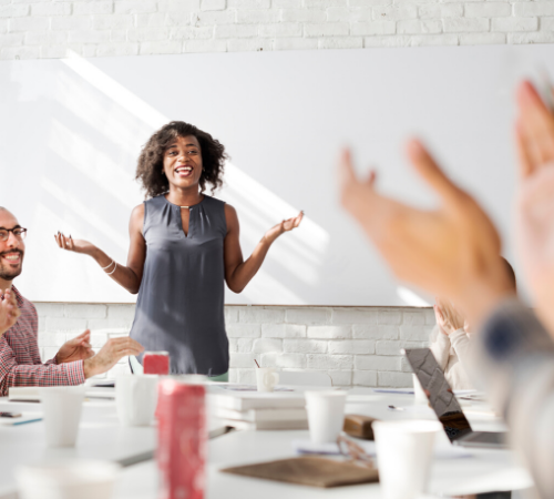 woman leading an office meeting smiling