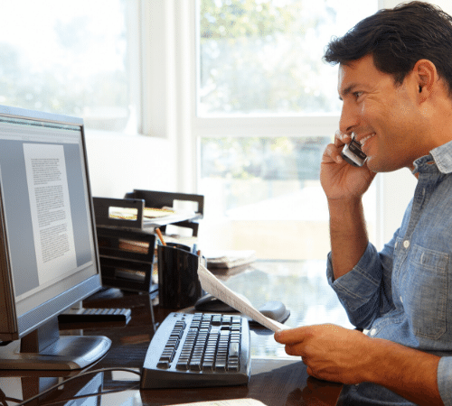 Person on the phone whilst working at home