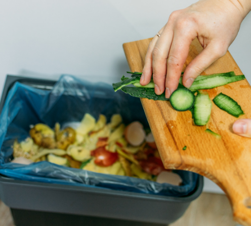 putting food into business food waste bin