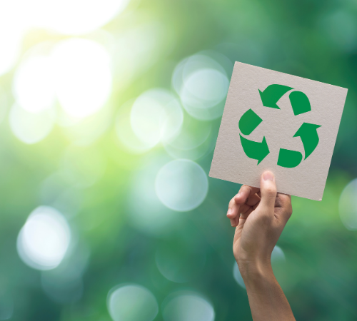 sign with recycling symbol held up