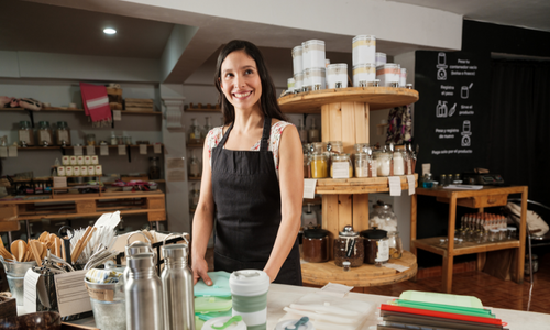 Coffee shop owner looking happy in her store